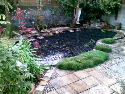 Garden pond fitted with SAFADECK pond grid below deck fitted by Pond Safety Systems, Ireland