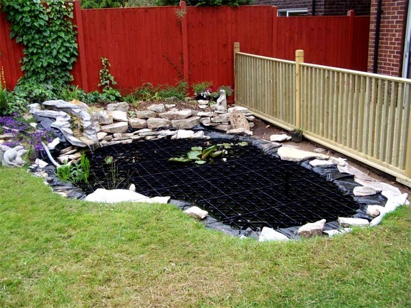 Pond with safety grid above water - Pond Safety Systems, Ireland